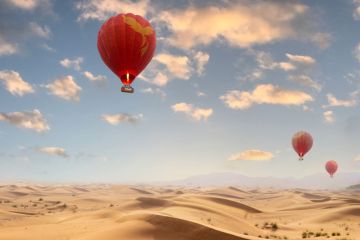 Drift peacefully over the vast desert landscapes of Ras Al Khaimah in a hot air balloon.